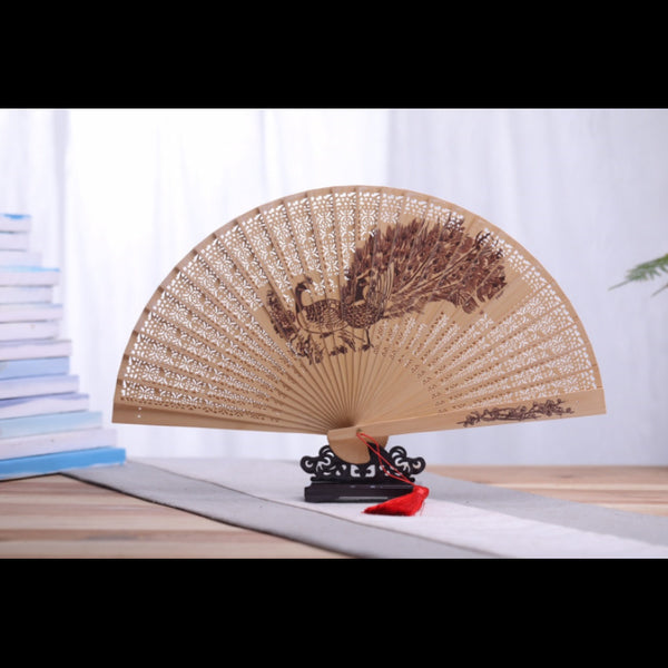 Hollow gold wire nanmu folding fan